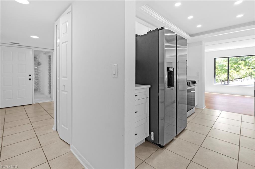 Image 4: Kitchen featuring recessed lighting, stainless steel appliances, light countertops, light tile patterned floors, and white cabinets