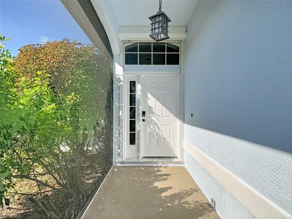 Image 3: Entrance to property featuring stucco siding