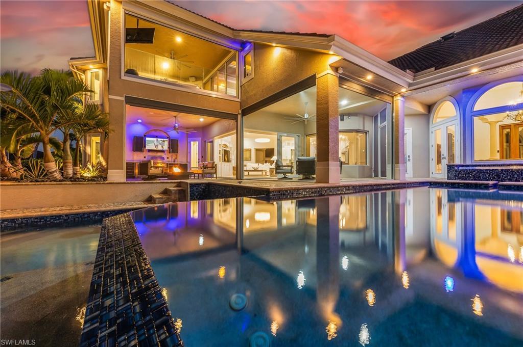 Image 3: Outdoor pool with a patio area and an in-ground hot tub