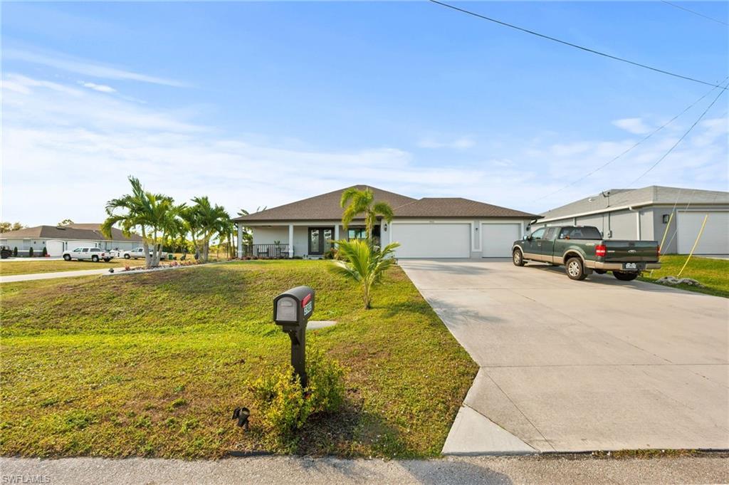 Image 1: Ranch-style house featuring a front lawn, driveway, and an attached garage