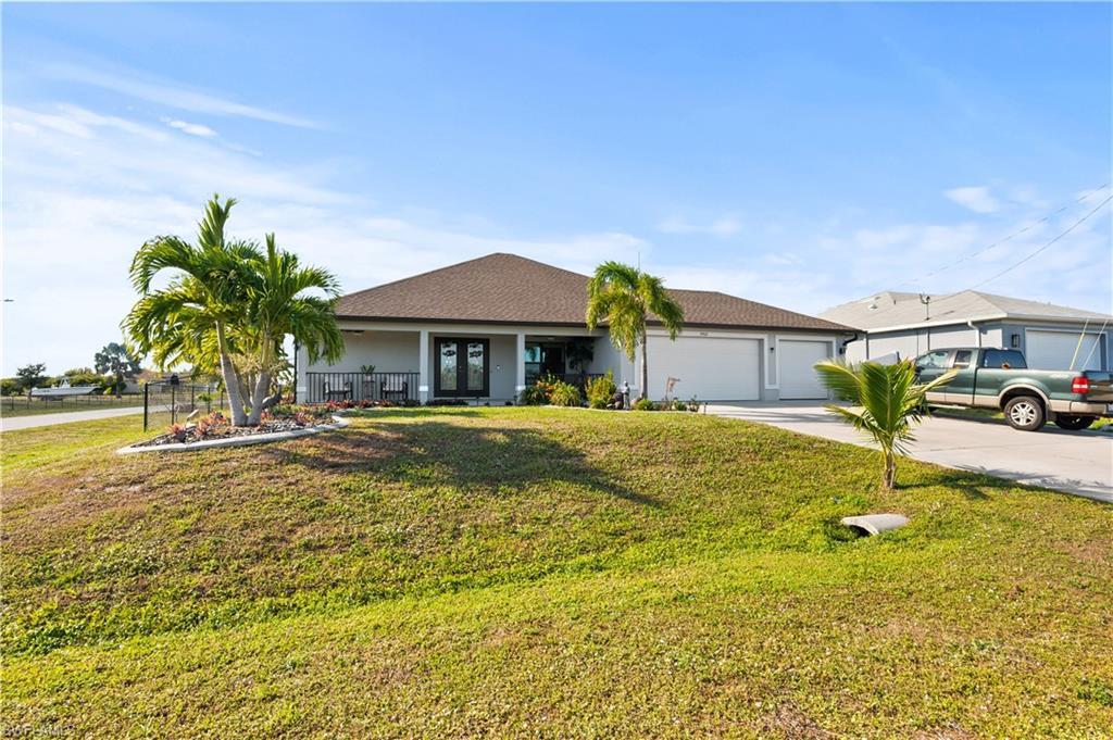 Image 2: Ranch-style home with driveway, roof with shingles, a garage, a porch, and stucco siding