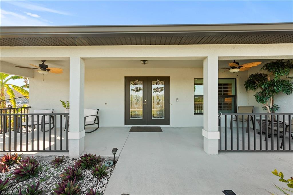Image 3: Property entrance with ceiling fan and stucco siding