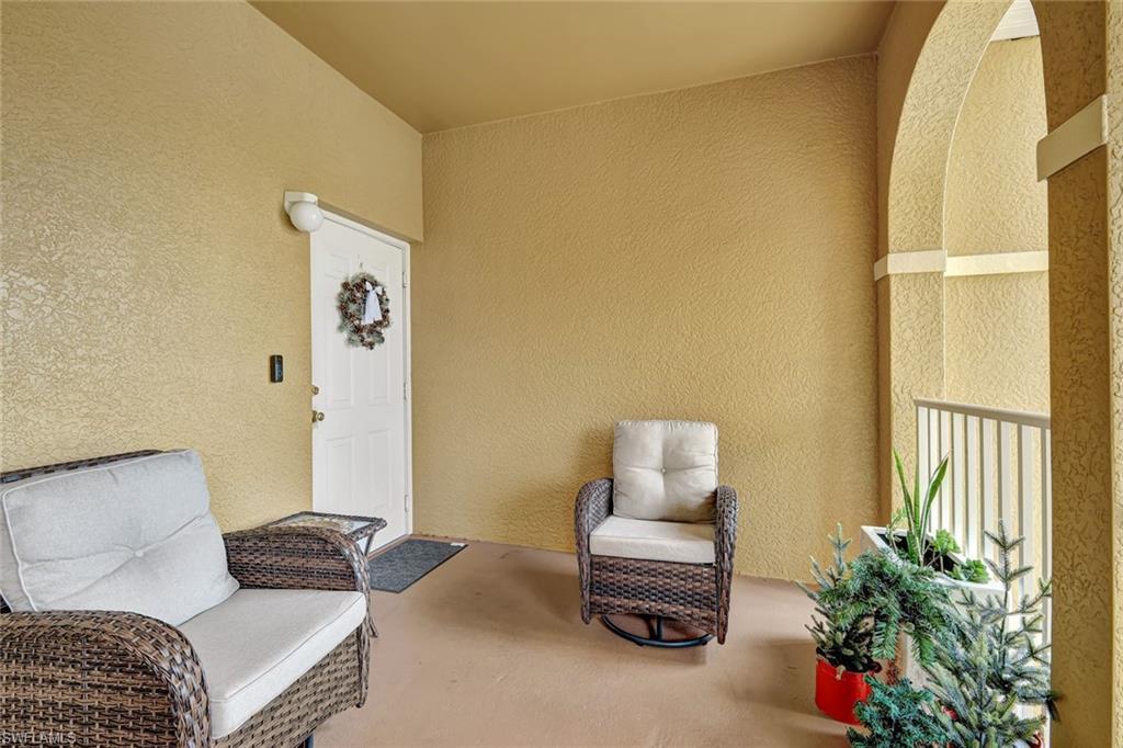 Image 3: Doorway to property featuring stucco siding