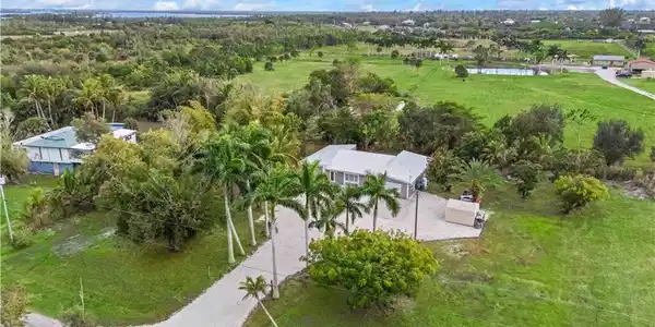 Image 3: Tucked away on over an acre, this gated Pine Island retreat offers peace, privacy, and space to breathe.