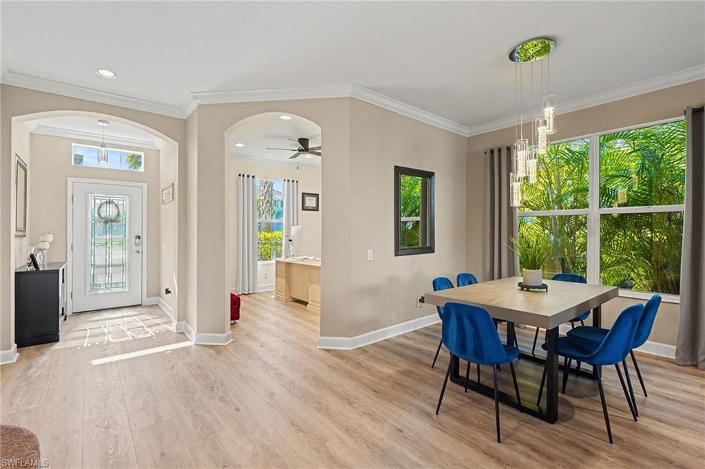 Image 2: Dining area featuring ornamental molding, a ceiling fan, light wood-style floors, plenty of natural light, and recessed lighting