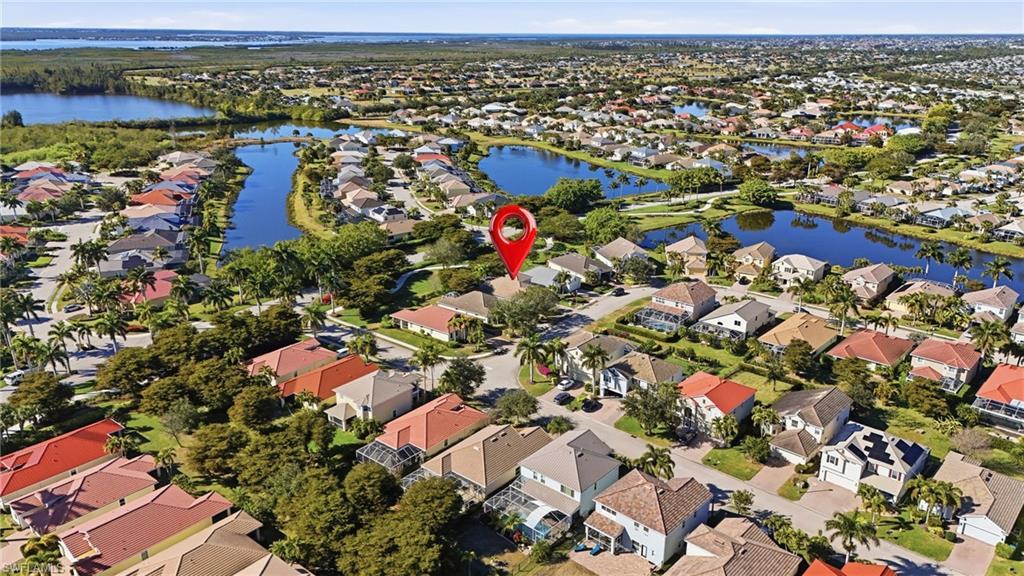 Image 3: Aerial overview of property's location featuring nearby suburban area and a nearby body of water