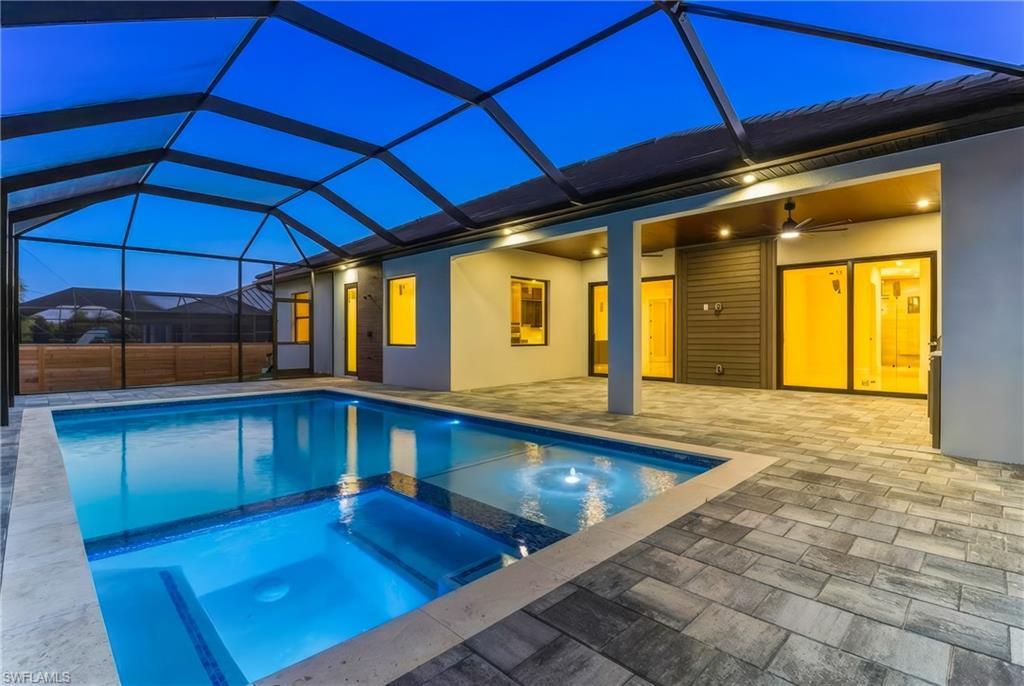 Image 3: Relaxing pool / spa featuring screened enclosure, and a patio area