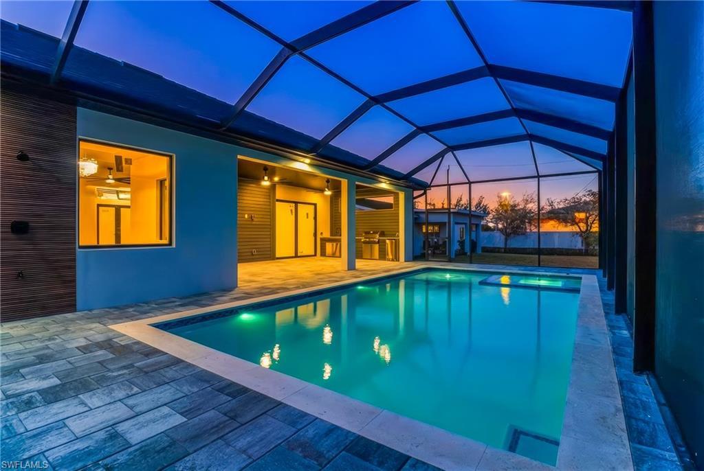 Image 4: Pool at dusk with an outdoor pool, a patio area, screened enclosure pool cage