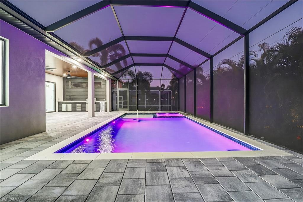 Image 4: Outdoor pool featuring a lanai, an in-ground hot tub and a patio area