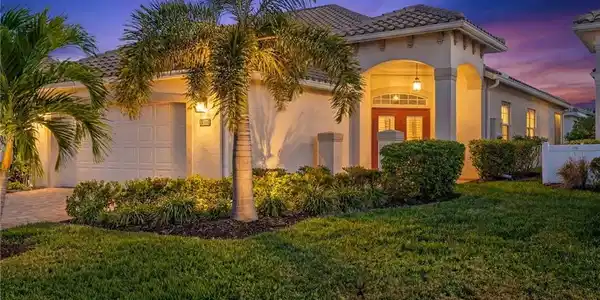 Image 2: Mediterranean / spanish-style house featuring stucco siding, french doors, a garage, a yard, and driveway