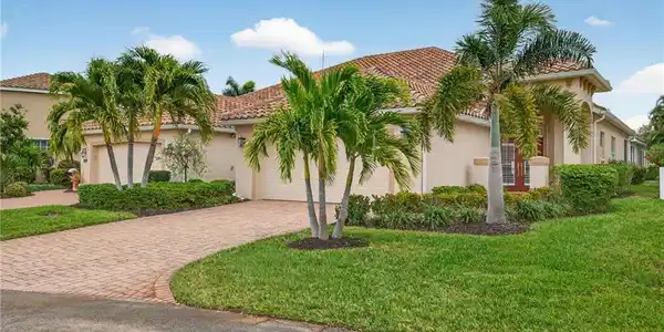 Image 4: Mediterranean / spanish house with stucco siding, a front yard, decorative driveway, and a tiled roof