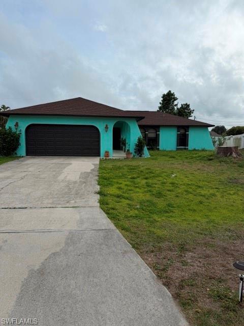Image 2: Single story home featuring stucco siding, driveway, a garage, a front yard, and roof with shingles