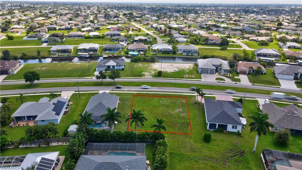 Image 1: Aerial view of residential area featuring property boundaries highlighted