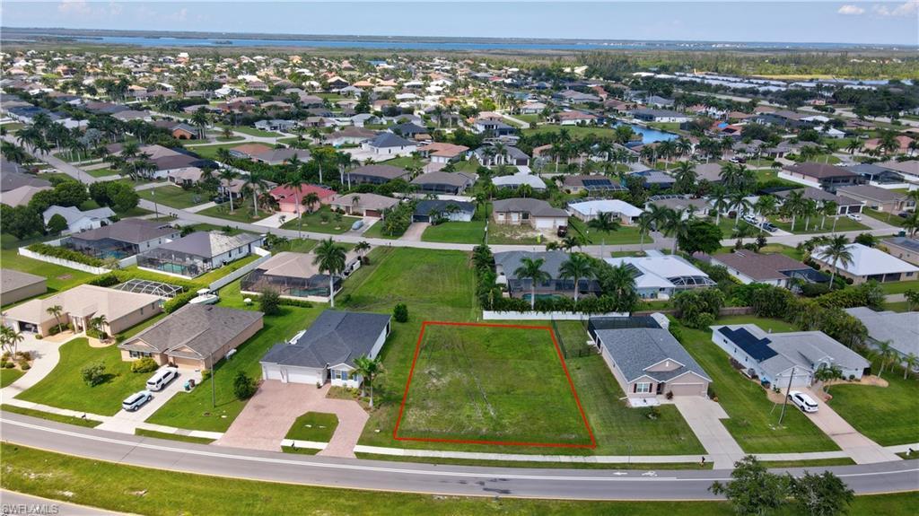 Image 2: Aerial perspective of suburban area with property parcel outlined