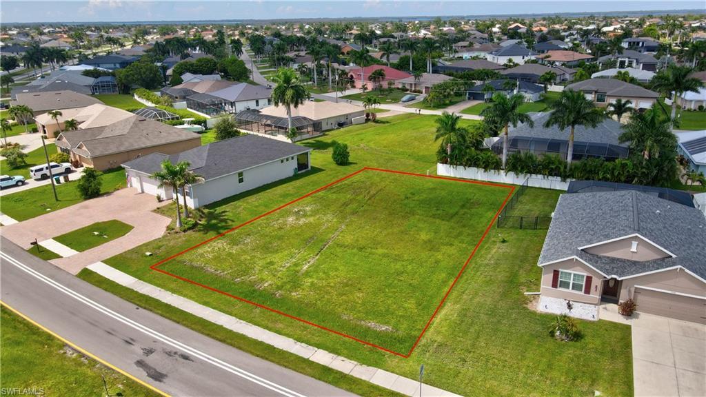 Image 3: Aerial view of residential area featuring property parcel outlined