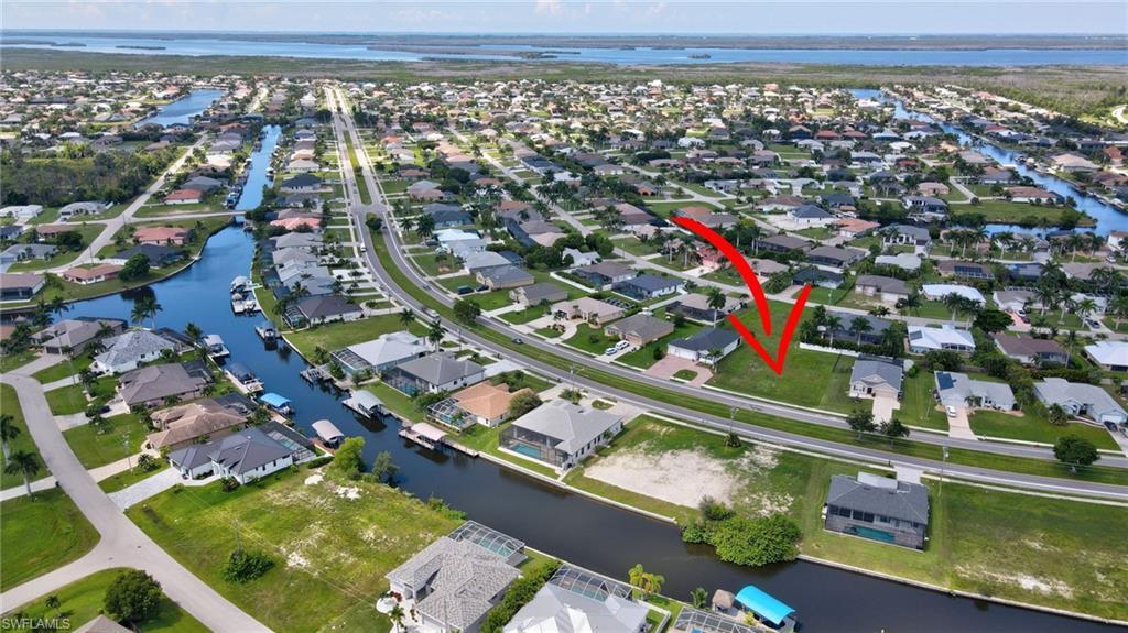 Image 4: View of property location featuring nearby suburban area and a nearby body of water