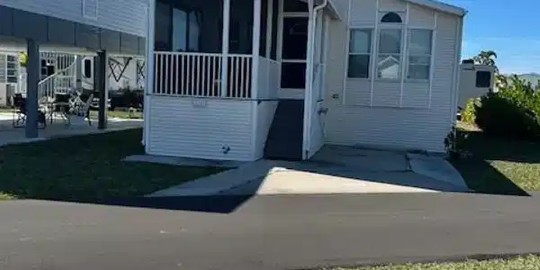 Image 3: Manufactured / mobile home with a sunroom and a front yard