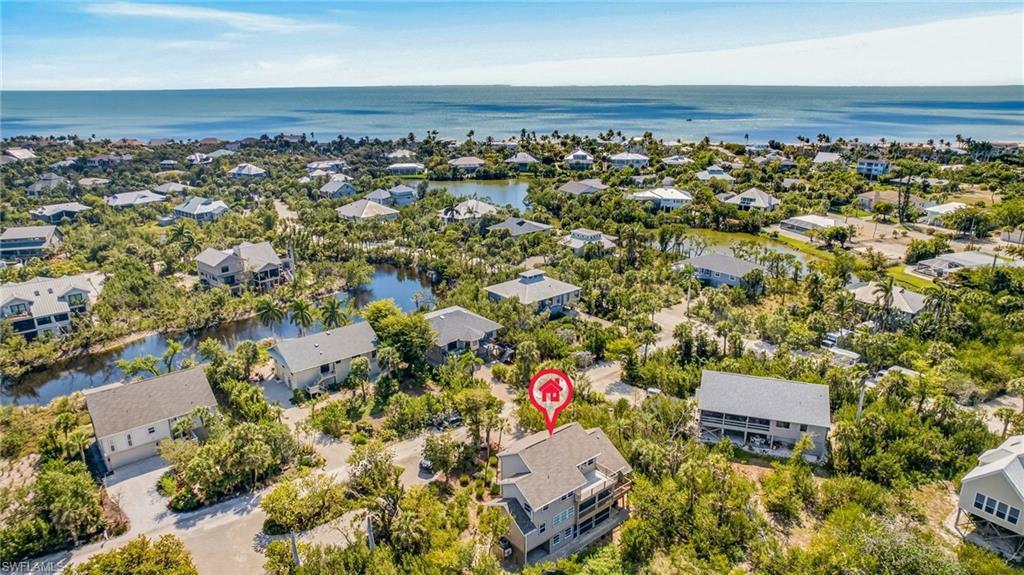 Image 2: Aerial view of residential area featuring a large body of water