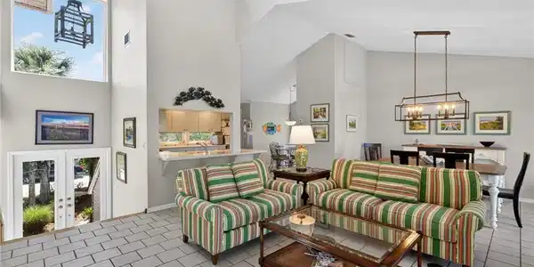 Image 4: Living area featuring a chandelier, a high ceiling, and french doors