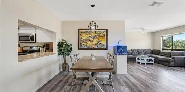 Image 4: The living area is bright, welcoming, and perfectly positioned to enjoy the waterfront setting.