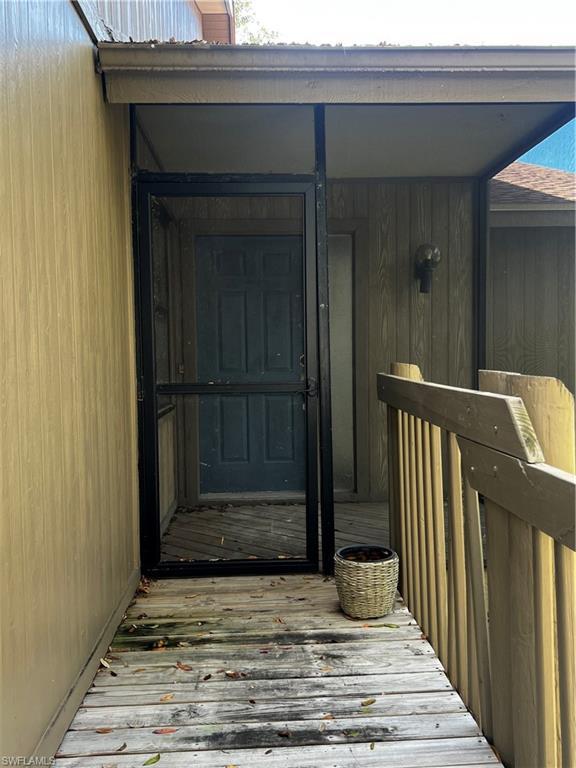 Image 3: View of exterior entry with a deck and a chimney