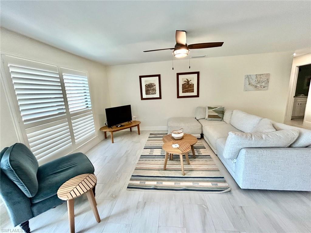 Image 2: Living area featuring light flooring and ceiling fan