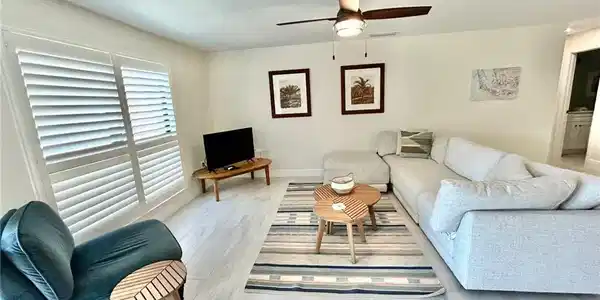 Image 2: Living area featuring light flooring and ceiling fan