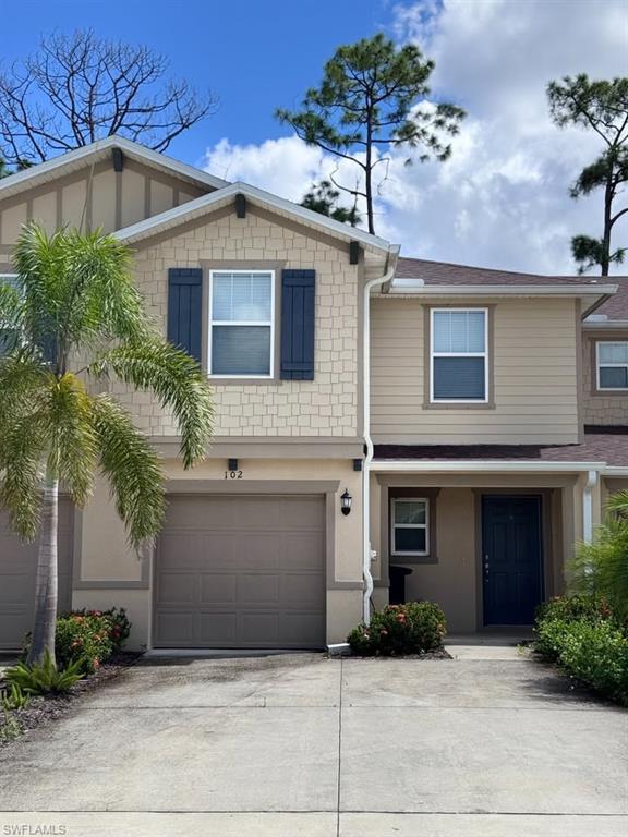 Image 2: View of front facade with driveway and an attached garage