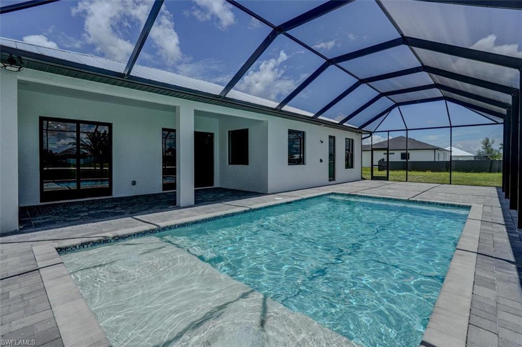 Image 2: View of swimming pool with a lanai and a patio
