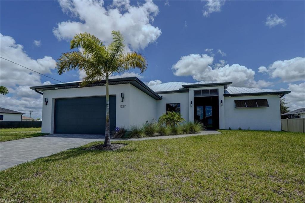 Image 3: View of front of house featuring a garage and a front lawn