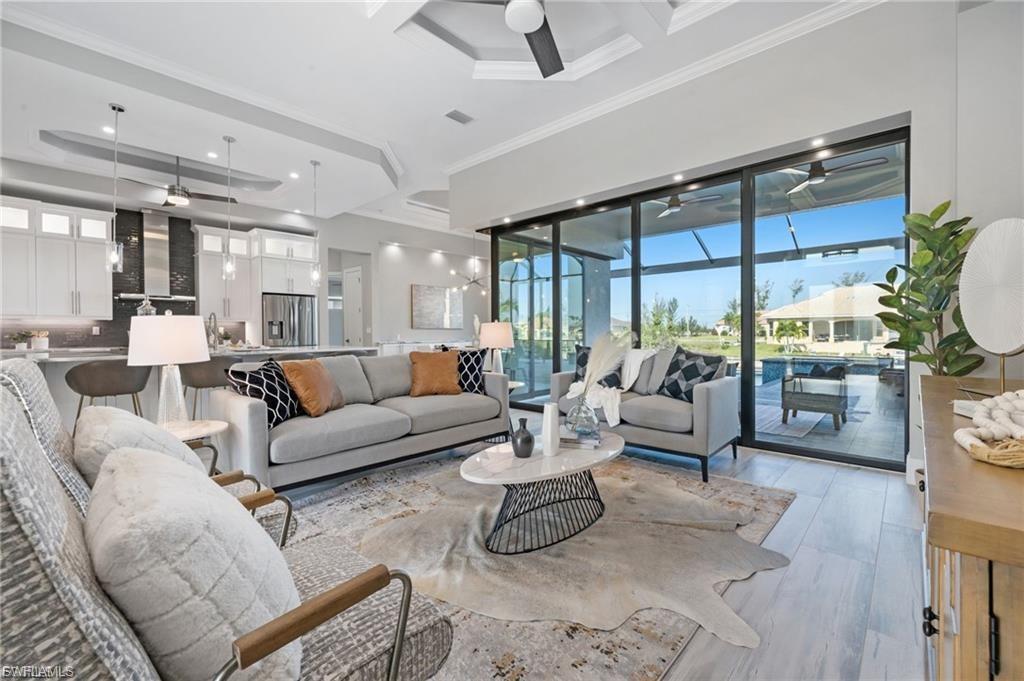 Image 4: Living area overlooks lanai & pool