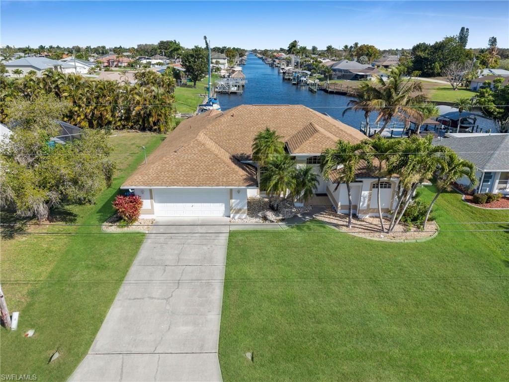 Image 2: Aerial perspective of suburban area featuring a large body of water