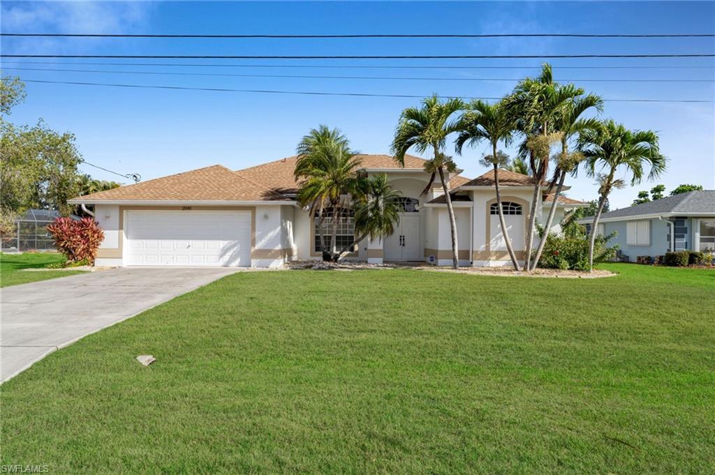 Image 3: Ranch-style house featuring a garage, driveway, a front yard, stucco siding, and a shingled roof
