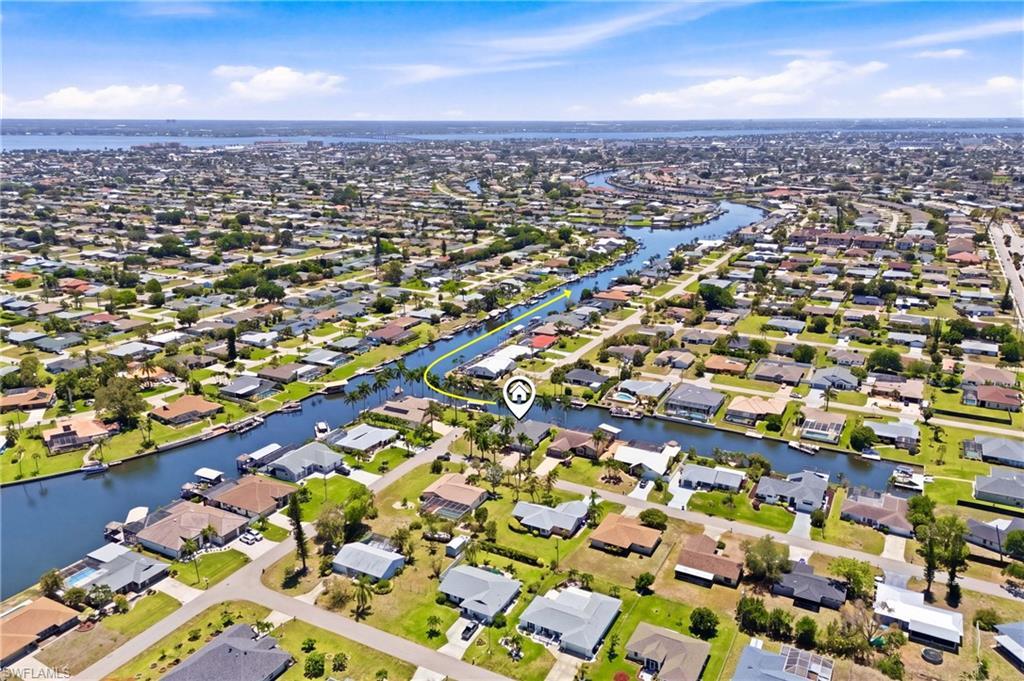 Image 2: Aerial view showcasing the property's waterfront location, surrounded by canals and residential properties