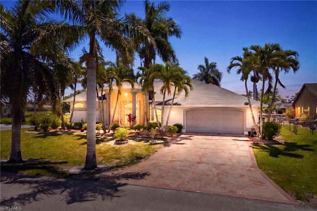 Image 3: The property features a well-maintained exterior with a white facade, a two-car garage, and an inviting driveway