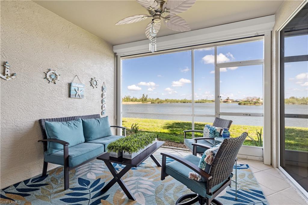 Image 3: Sunroom / solarium with a textured wall, a ceiling fan, an outdoor lounge area, a water view, and tile patterned flooring