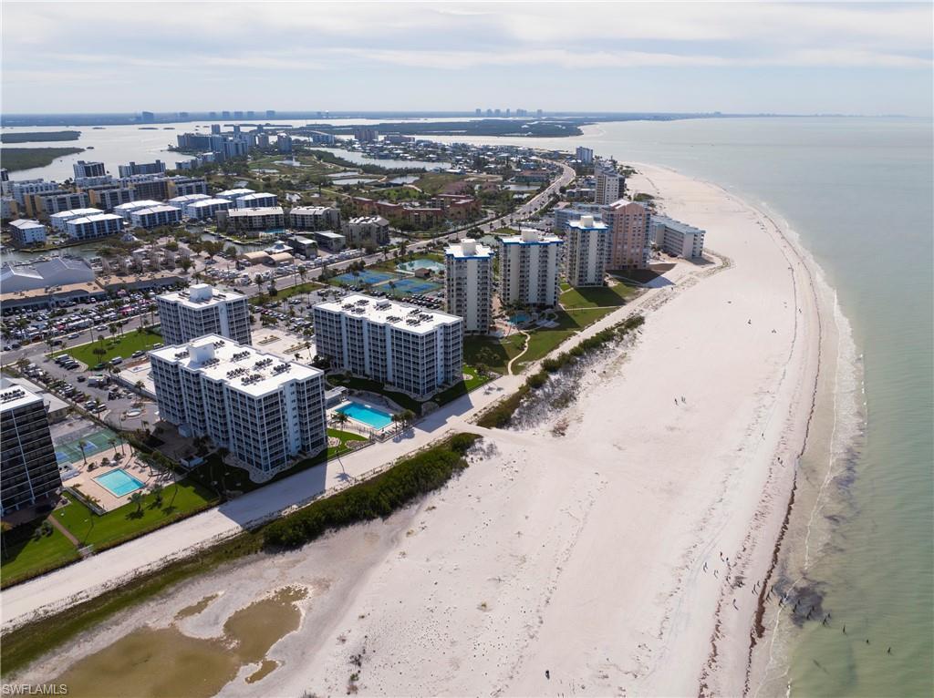 Image 3: Aerial view of expansive coastline and a pool