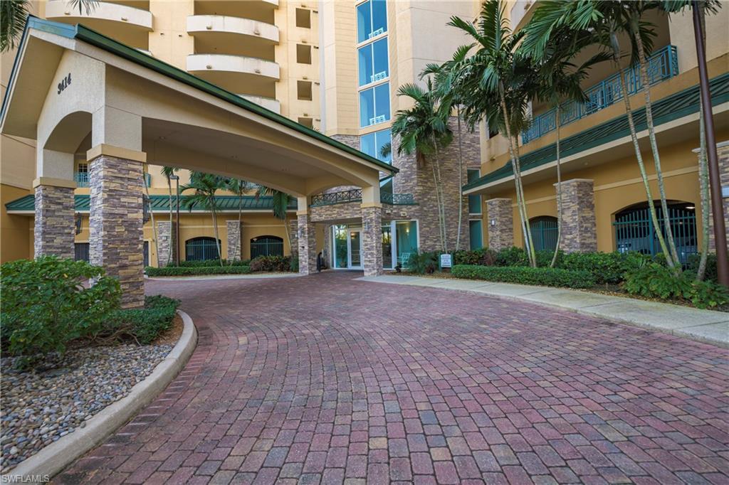 Image 1: Expansive paver driveway leading to a covered porte-cochere entrance