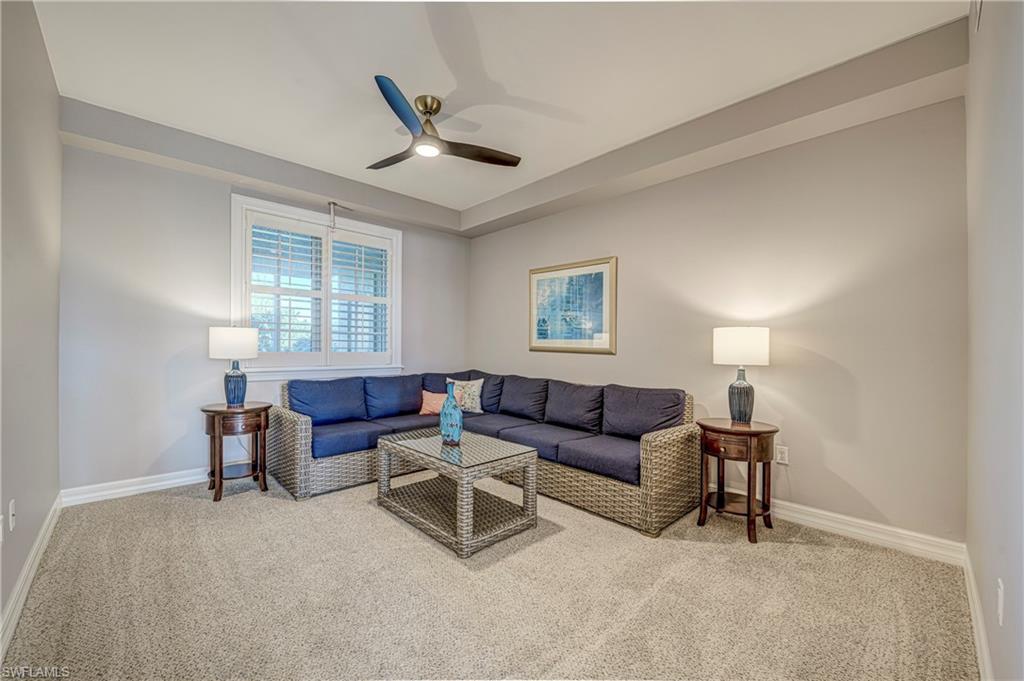 Image 3: Carpeted room featuring a ceiling fan with integrated lighting, a window with plantation shutters, light gray walls, and white baseboards
