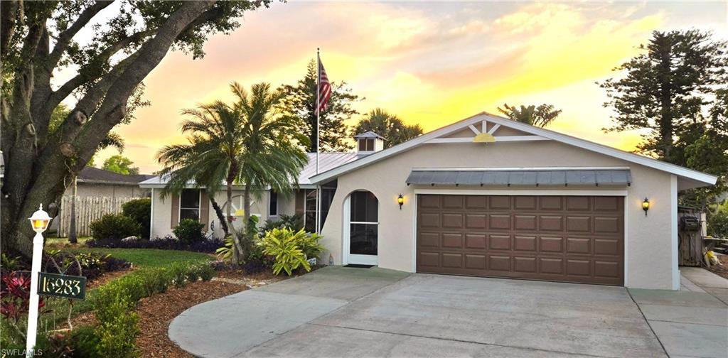 Image 1: Single story home featuring stucco siding, concrete driveway, an attached garage, a metal roof, and a standing seam roof