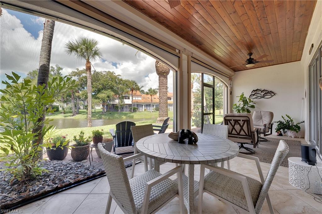 Image 4: Enjoy serene lake views from your screened in lanai, where a tongue-and-groove ceiling adds warmth and character, complemented by newly installed hurricane screens for enhanced comfort and peace of mind.