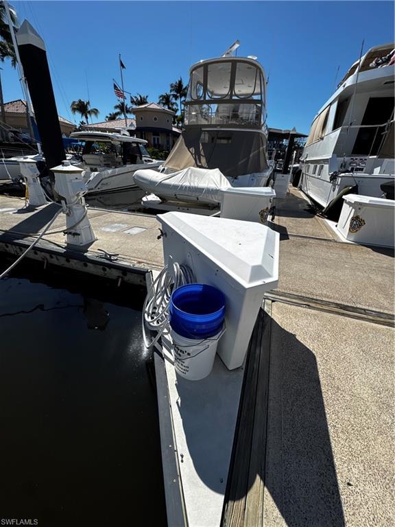 Image 4: Dockside setting with a concrete surface and wooden pilings