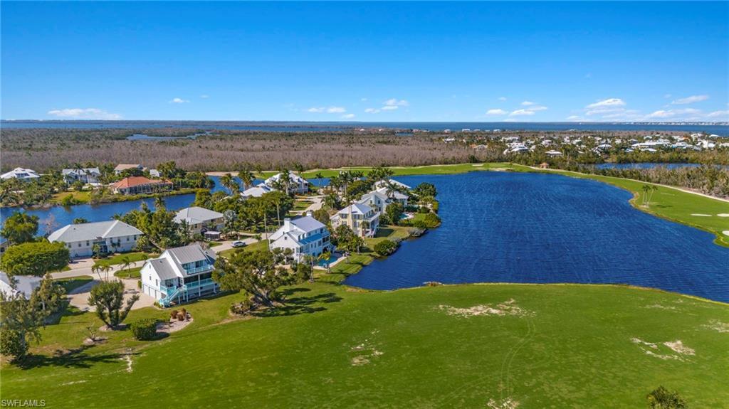 Image 2: Aerial view of residential area featuring a large body of water and a local golf course