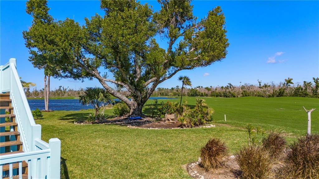 Image 3: View of green lawn with a water view and golf course view