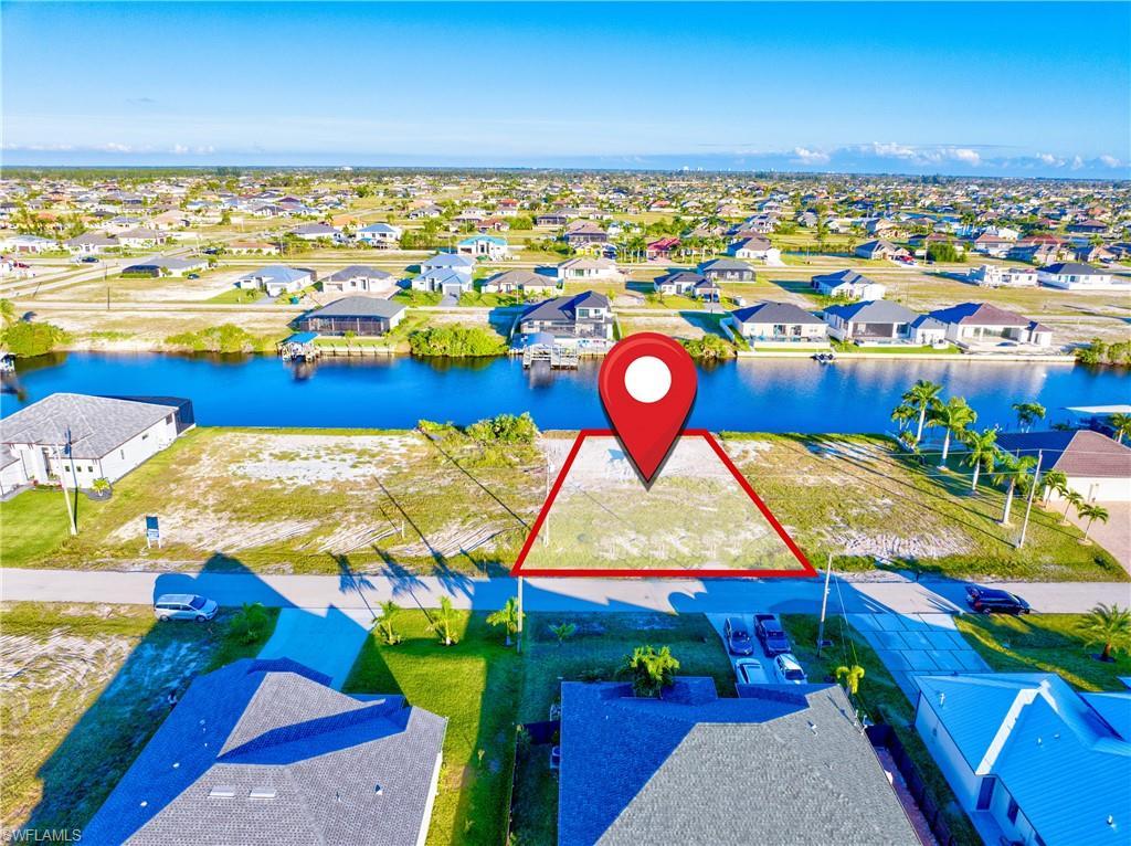 Image 3: Canal-front lot featuring clear boundaries, direct water access, and proximity to established residences