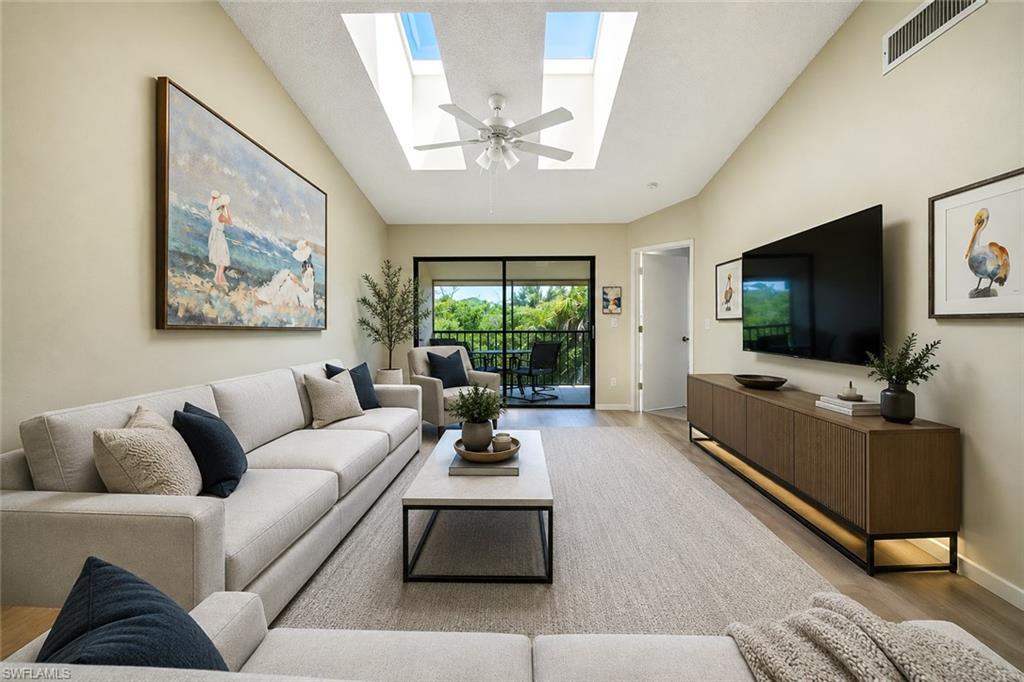 Image 2: Vaulted ceiling with skylights and a ceiling fan