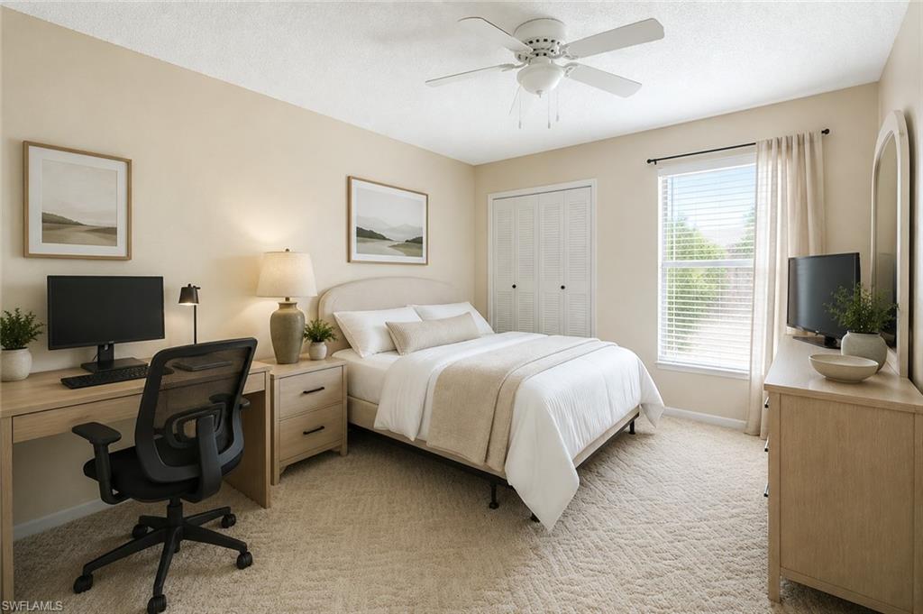 Image 4: Carpeted bedroom featuring a ceiling fan, a window with blinds and drapes, and bi-fold closet doors