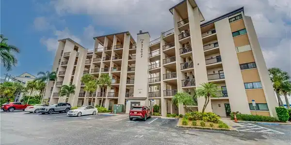 Image 2: Multi-story building with multiple balconies and exterior lighting