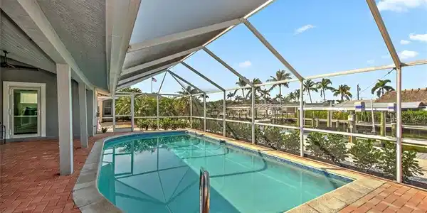 Image 2: View of swimming pool featuring a lanai and a patio area