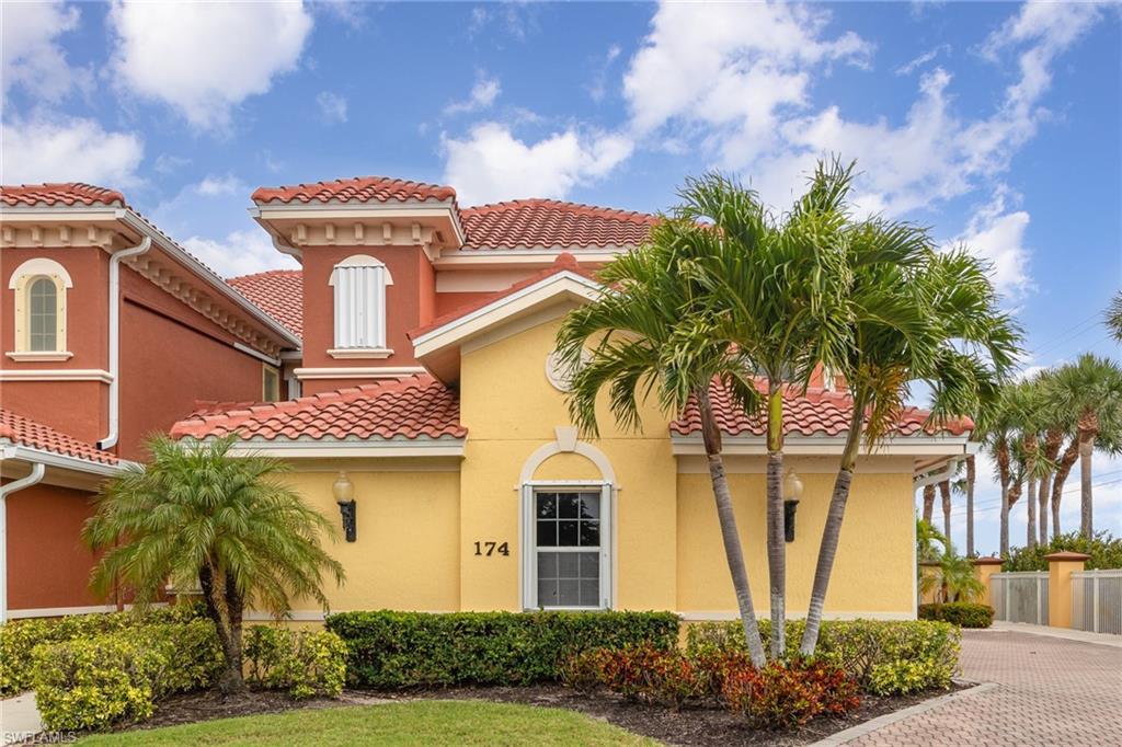 Image 3: Mediterranean / spanish-style house featuring fence, a tile roof, and stucco siding